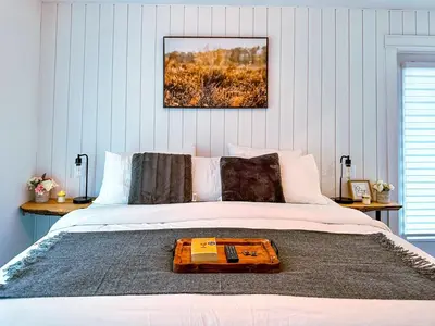 a bedroom with a bed with a wooden tray on it at Greenview Retreat in Collingwood