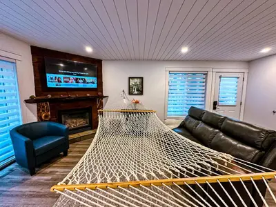 a living room with a hammock in front of a tv at Greenview Retreat in Collingwood