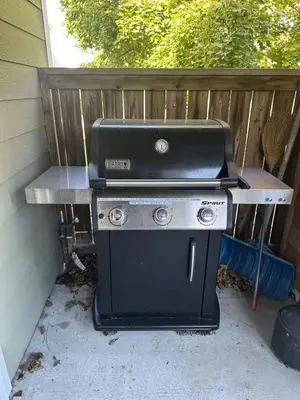 a grill sitting on a table next to a fence at Pony Trail in Collingwood