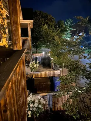 a porch of a house at night with flowers at Pony Trail in Collingwood
