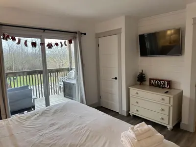 a bedroom with a bed and a tv on the wall at Pony Trail in Collingwood