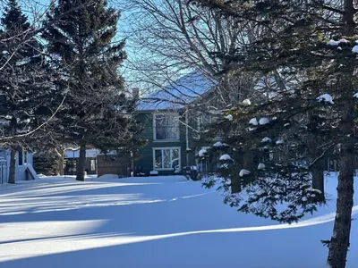 a blue house with a yard covered in snow at Pony Trail in Collingwood
