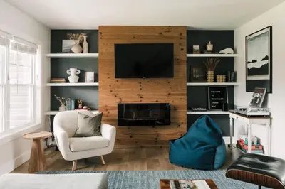 a living room with a fireplace and a tv at Woodland Chase in Wellington