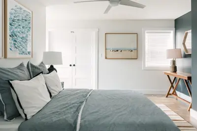 a bedroom with a bed and a ceiling fan at Woodland Chase in Wellington