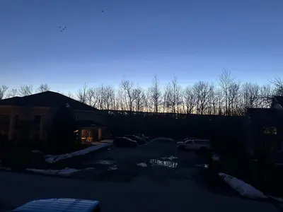 a parking lot with a car in a driveway at 19th Hole Hideaway in Collingwood