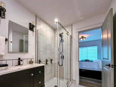 a bathroom with a shower and a sink at The Fairway Flat in Collingwood