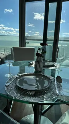 a glass table with a plate on top of it at DOWNTOWN, LUXURY CONDO, CN TOWER, ROGERS CENTER, SCOCIA ARENA, UNOBSTRUCTED VIEW in Toronto