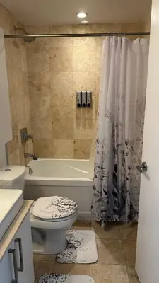 a bathroom with a toilet and a tub and a shower at DOWNTOWN, LUXURY CONDO, CN TOWER, ROGERS CENTER, SCOCIA ARENA, UNOBSTRUCTED VIEW in Toronto