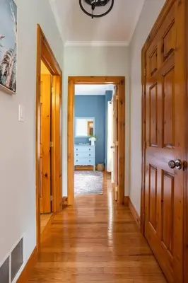 a hallway with wooden floors and a room with a door at Cosy Chalet - 4 Season Family Oasis in Collingwood