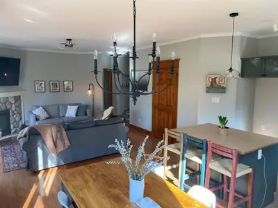 a living room with a blue couch and a table at Cosy Chalet - 4 Season Family Oasis in Collingwood