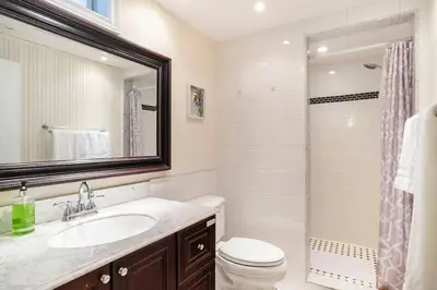 a bathroom with a sink and a toilet and a shower at Cozy basement apartment in Newmarket in Newmarket
