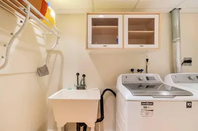 a small bathroom with a sink and a washing machine at Cozy basement apartment in Newmarket in Newmarket