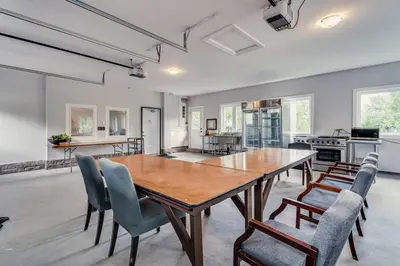 a kitchen and dining room with a wooden table and chairs at Large Estate with Luxury Collection of Amenities in Schomberg