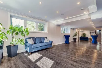 a living room with a blue couch and some windows at Large Estate with Luxury Collection of Amenities in Schomberg