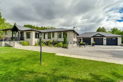 a house with a grass yard in front of it at Large Estate with Luxury Collection of Amenities in Schomberg
