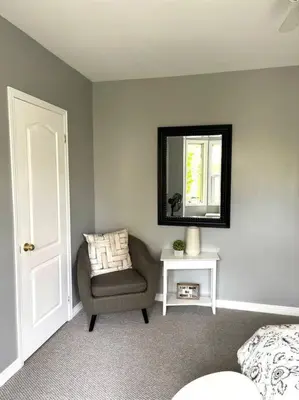 a bedroom with a chair and a mirror on the wall at Superb Spacious Loft Old Toronto near Distillery District in Toronto