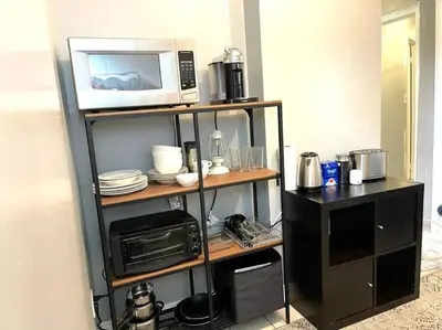 a shelf with a microwave and a toaster oven at Superb Spacious Loft Old Toronto near Distillery District in Toronto