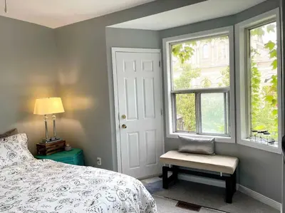 a bedroom with a bed and a window and a chair at Superb Spacious Loft Old Toronto near Distillery District in Toronto