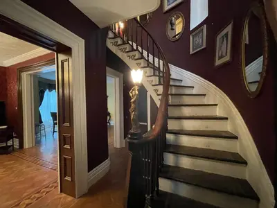 a spiral staircase in a home with a hallway at THE RED HOUSE in Niagara Falls