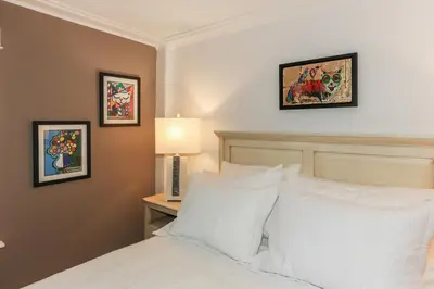 a bedroom with a bed and a table with a lamp at The Royal Manor Inn in Niagara on the Lake
