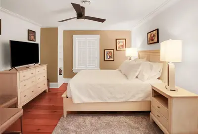 a bedroom with a bed and a flat screen tv at The Royal Manor Inn in Niagara on the Lake