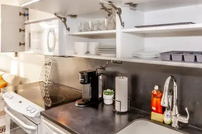 a kitchen with a sink and a counter top at SkyHigh Haven LED-Lit Downtown Condo Retreat in Toronto