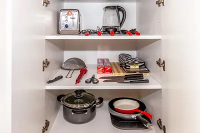 a kitchen shelving unit with a pot and other kitchen items at SkyHigh Haven LED-Lit Downtown Condo Retreat in Toronto