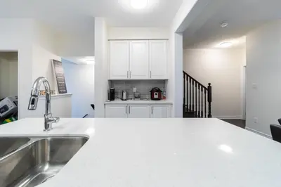 a kitchen with white cabinets and a white counter top at Beautiful New Townhouse in Quiet Neighbourhood in Ajax