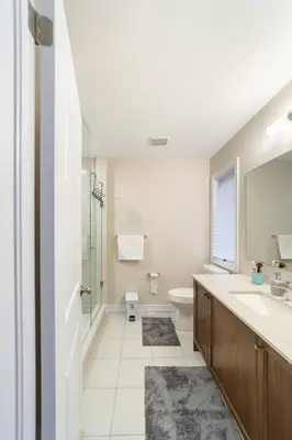 a bathroom with a sink and a toilet and a mirror at Beautiful New Townhouse in Quiet Neighbourhood in Ajax