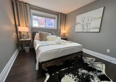 a bedroom with a bed and a window and a rug at Rustic Elegance & Style 1BR in London