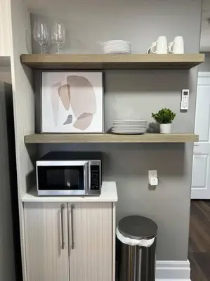 a microwave sitting on a counter in a kitchen at Rustic Elegance & Style 1BR in London