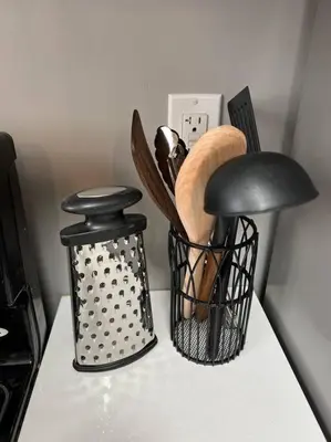 a kitchen counter with a rack of kitchen utensils at Rustic Elegance & Style 1BR in London