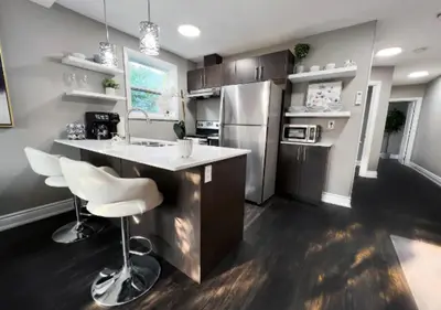 a kitchen with a counter and a refrigerator at Elegant City Living - 1 BR in London