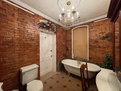 a bathroom with a white bath tub and a mirror at THE RED dragon in Niagara Falls