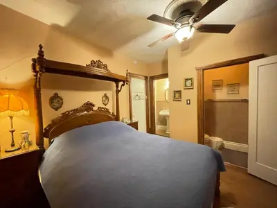 a bedroom with a bed and a ceiling fan at THE RED dragon in Niagara Falls