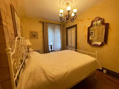 a bedroom with a white bed and a mirror at THE RED dragon in Niagara Falls