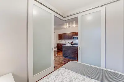 a bedroom with sliding doors leading to a kitchen at Prime City Pad 2 Bedroom with CN Tower View in Toronto