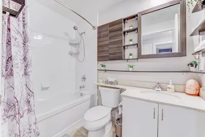 a bathroom with a toilet and a sink and a shower at Prime City Pad 2 Bedroom with CN Tower View in Toronto