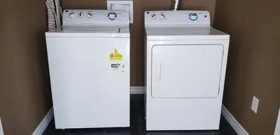 two white appliances sitting next to each other in a room at Stylish 3 Bdrm house- king bed, Netflix, parking in Kitchener