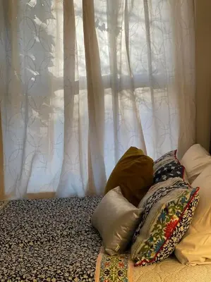 two pillows on a bed in front of a window at Vintage 2 bed 2 bath suite Distillery District in Toronto