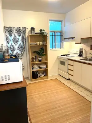a kitchen with white appliances and a wooden floor at Vintage 2 bed 2 bath suite Distillery District in Toronto