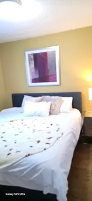 a bedroom with a bed with white sheets and pillows at short time rental in Kawartha Lakes