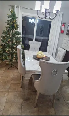 a dining room with a christmas tree and a table and chairs at short time rental in Kawartha Lakes