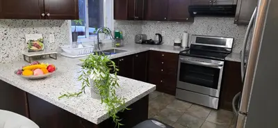 a kitchen with a counter with a bowl of fruit on it at short time rental in Kawartha Lakes