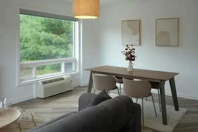 a living room with a table and a couch at Stay Inn Muskoka in Gravenhurst