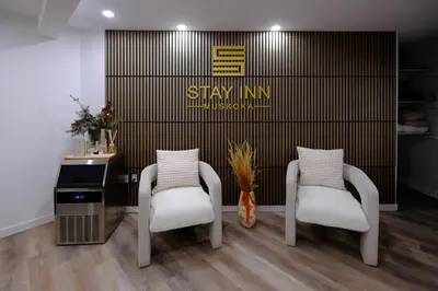 two chairs and a desk in a room at Stay Inn Muskoka in Gravenhurst