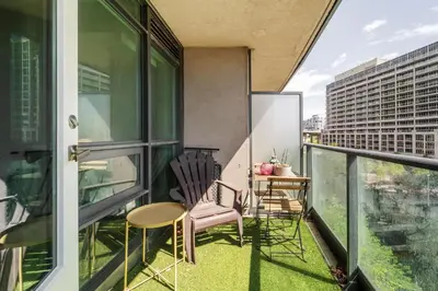 a balcony with chairs and a table on a building at Spacious 2 Bedroom plus Den, 2 Bath, Sleeps 5 with Balcony and Lakeview Downtown Toronto Condo in Toronto