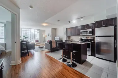 a kitchen and living room with a stove top oven at Spacious 2 Bedroom plus Den, 2 Bath, Sleeps 5 with Balcony and Lakeview Downtown Toronto Condo in Toronto