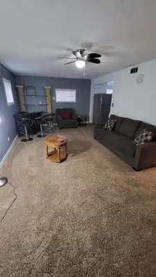 a living room with a couch and a table at Newly Furnished Modern Apartment in Welland