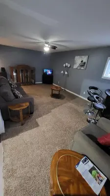 a living room with a couch and a tv at Newly Furnished Modern Apartment in Welland
